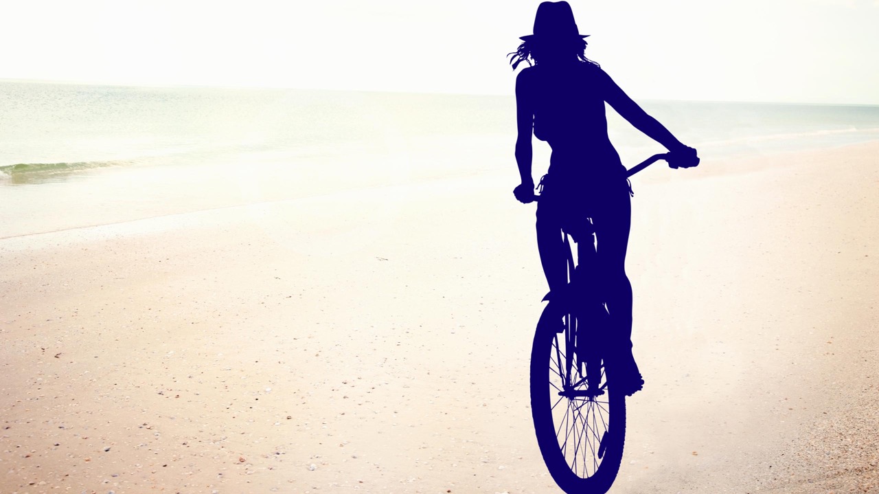 photoshop cut-out of girl cycling on the beach